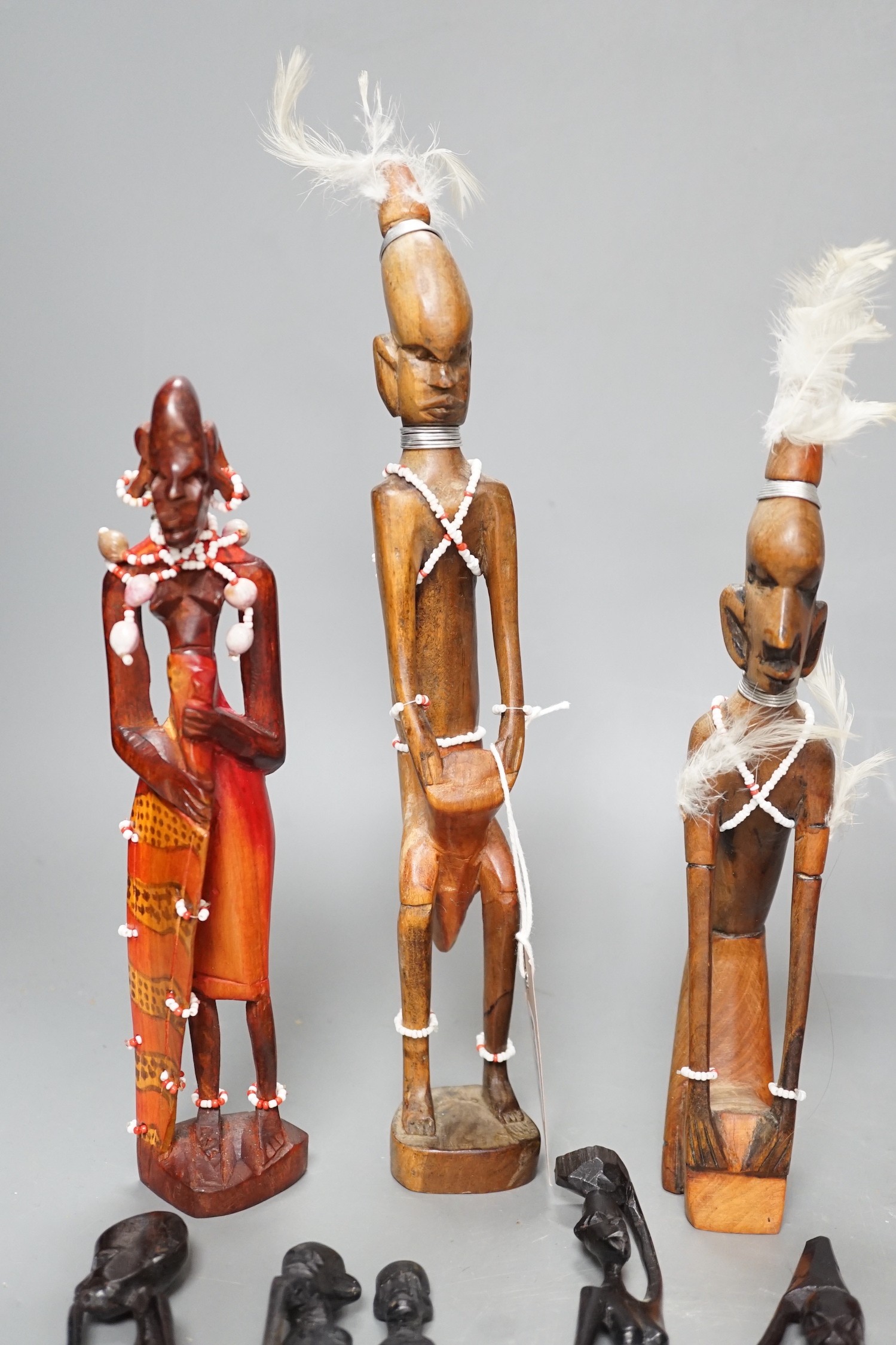 12 African carved wood stick figures, tallest 38cms high